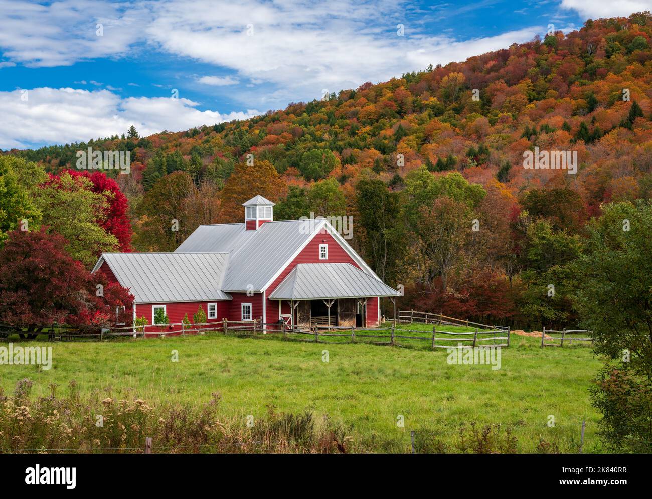 Aerial view of large red farm barn by the side of the road near Barnard in Vermont during the autumn color season Stock Photo