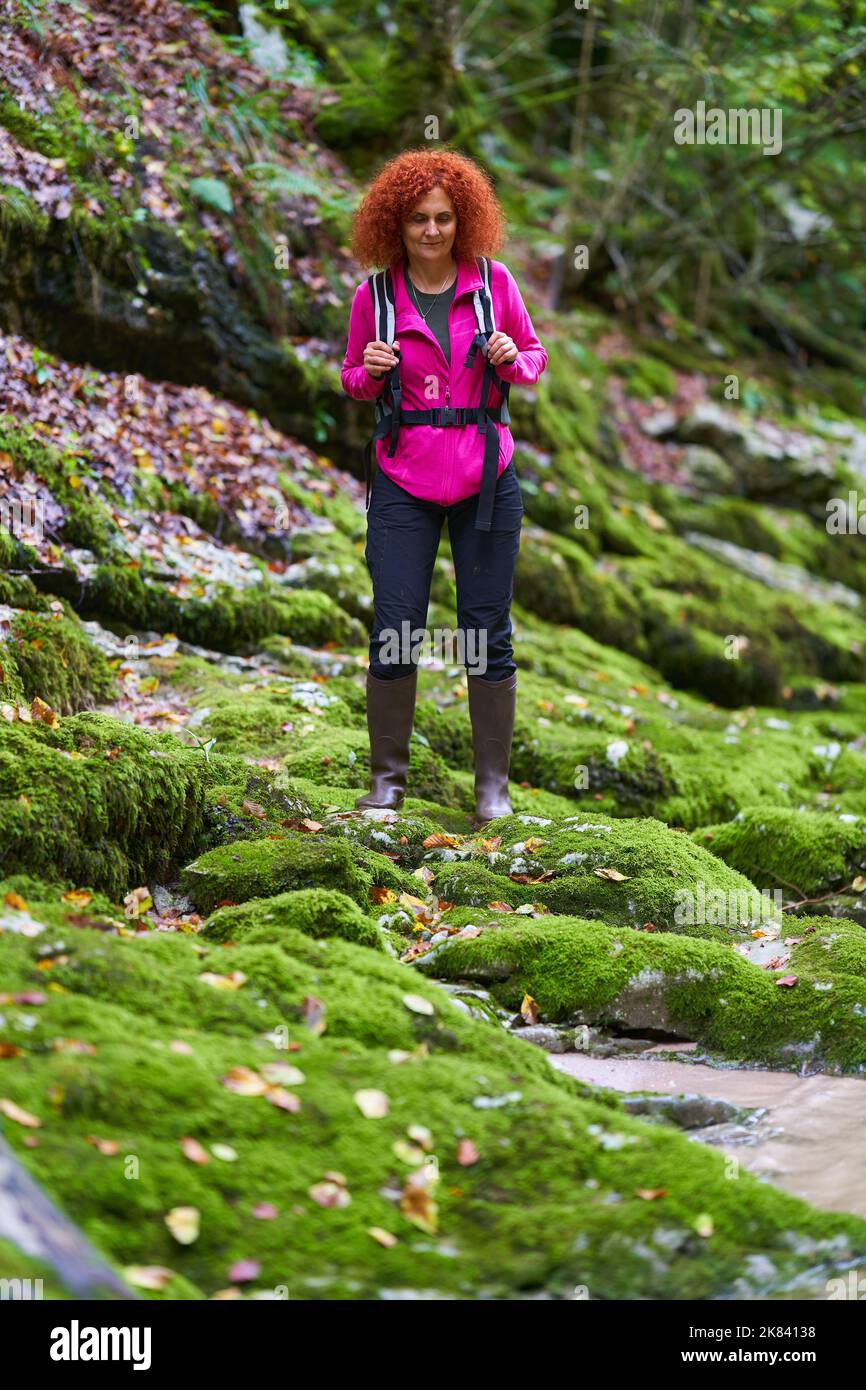 Curly redhead woman hiking in the wild forest Stock Photo - Alamy