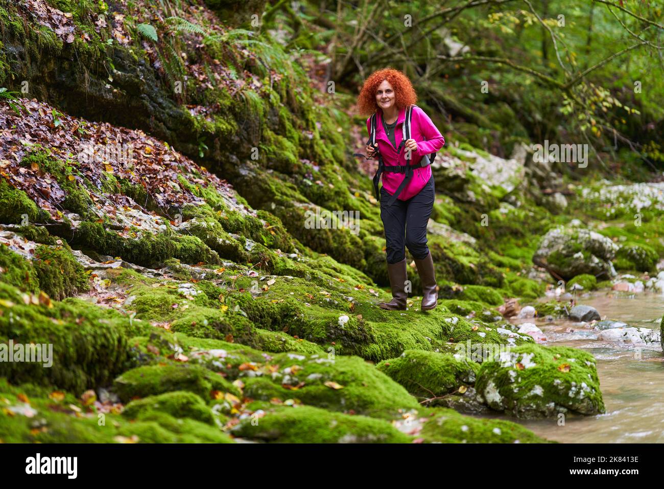 Curly redhead woman hiking in the wild forest Stock Photo - Alamy