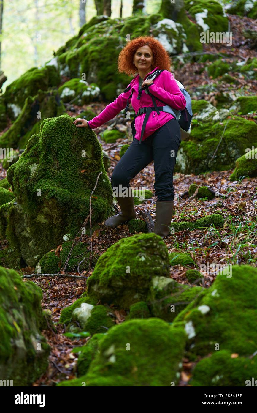 Curly redhead woman hiking in the wild forest Stock Photo - Alamy