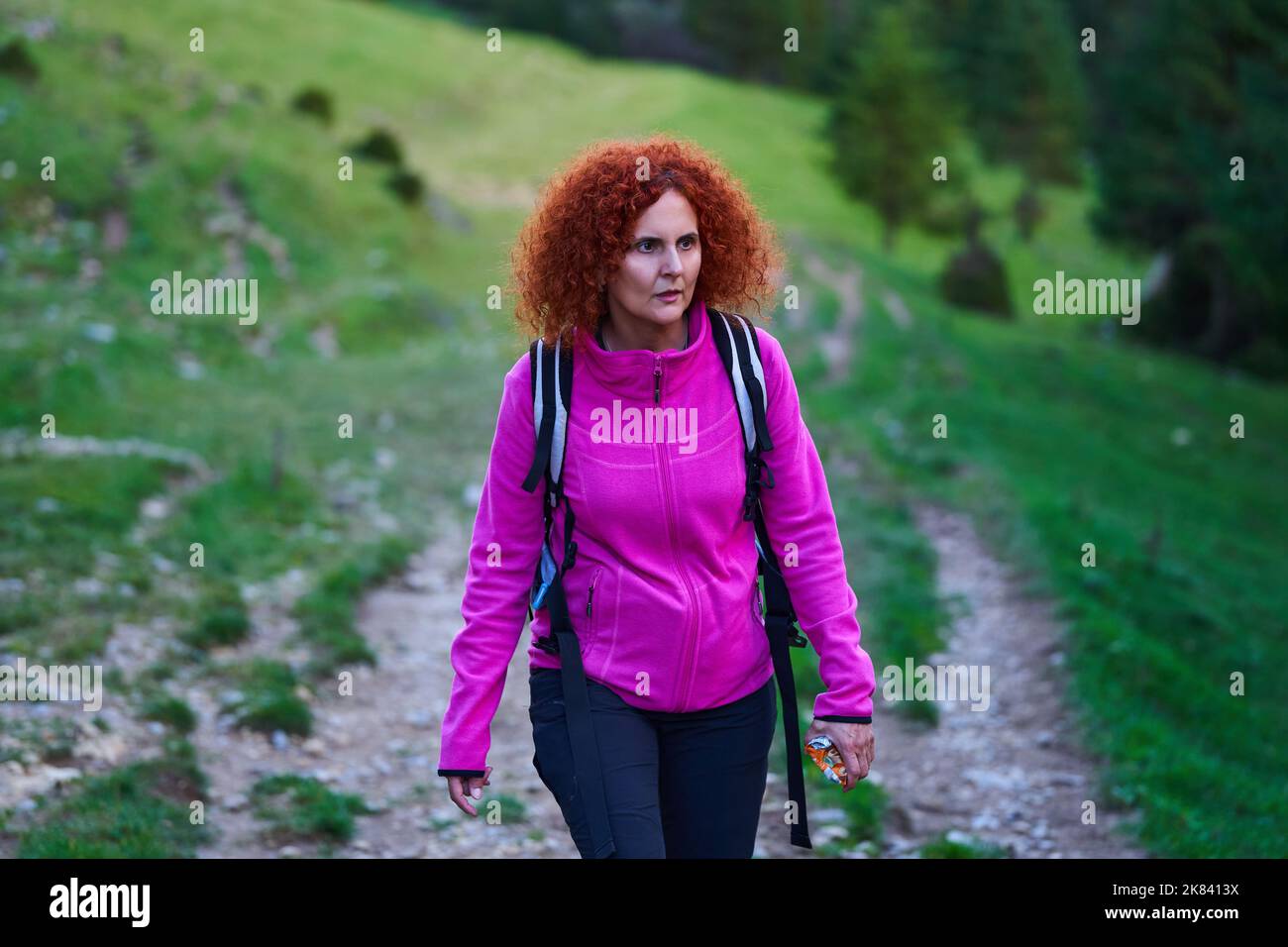 Curly redhead woman hiking in the wild forest Stock Photo - Alamy