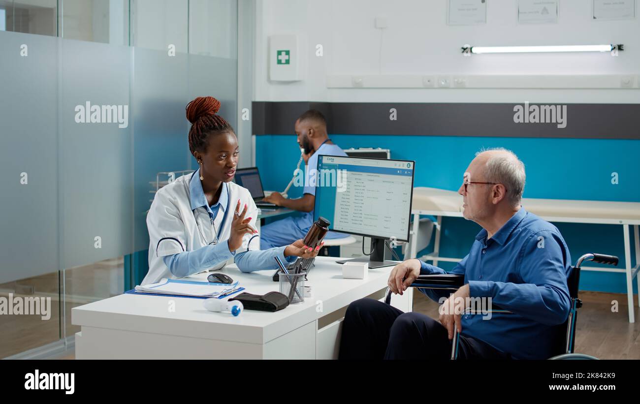 Health specialist giving prescription medicine in bottle of pills to ...