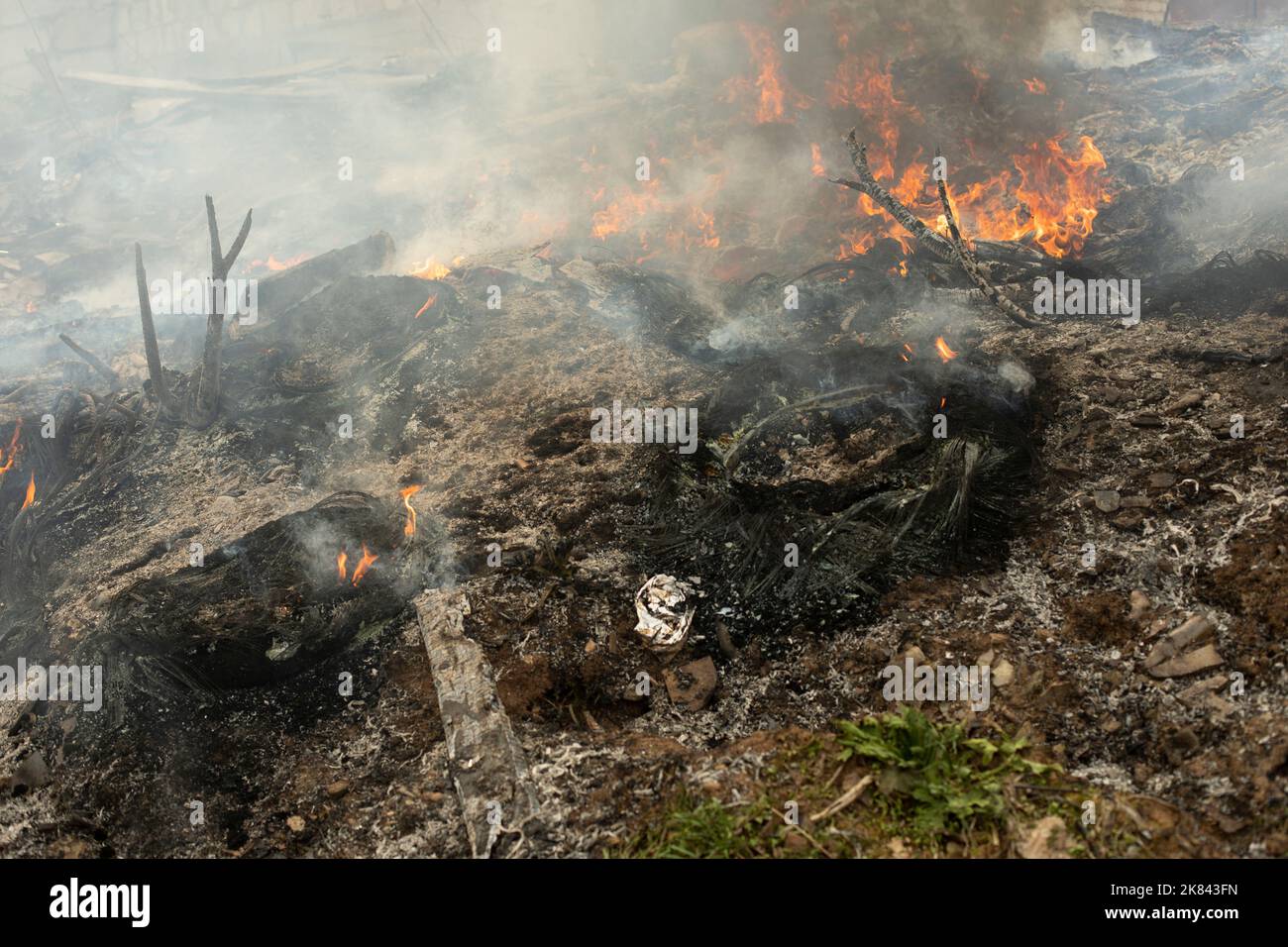 Burning of garbage. Set fire to illegal landfill. Flames and smoke