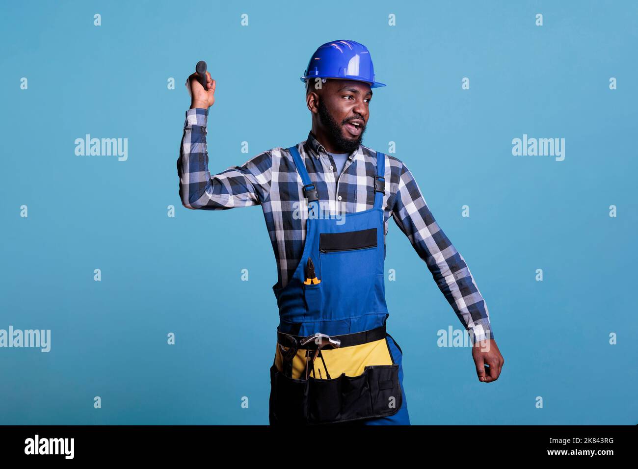 African american construction worker wearing coverall and tool belt