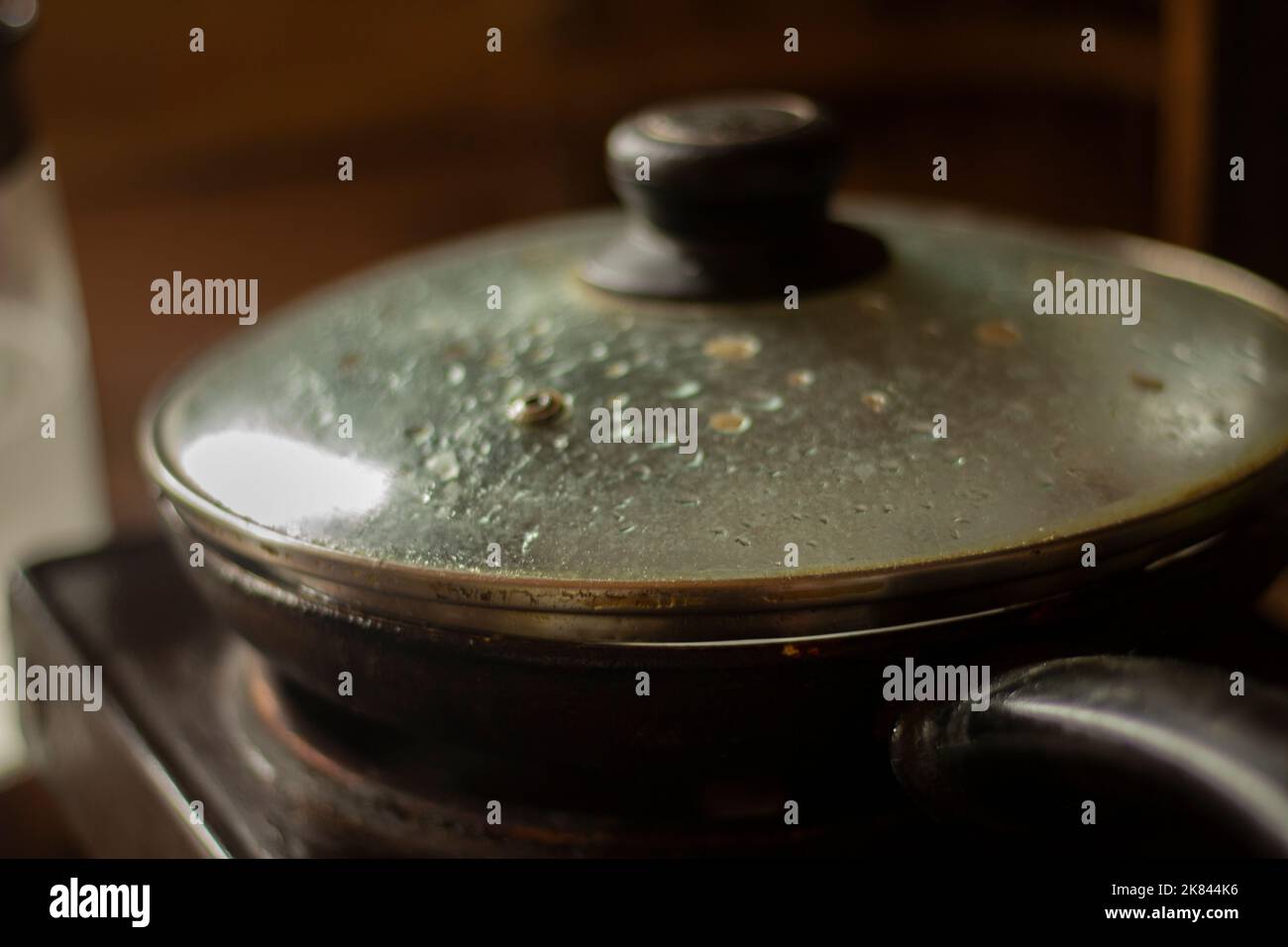 Frying pan in kitchen. Lid on frying pan. Cooking. Dirty dishes Stock