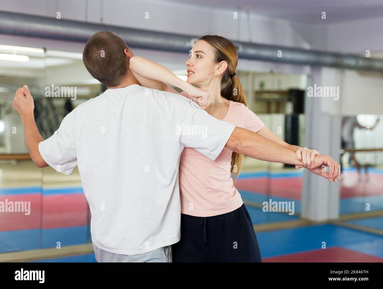 Woman performing elbow strike during selfdefence training Stock Photo