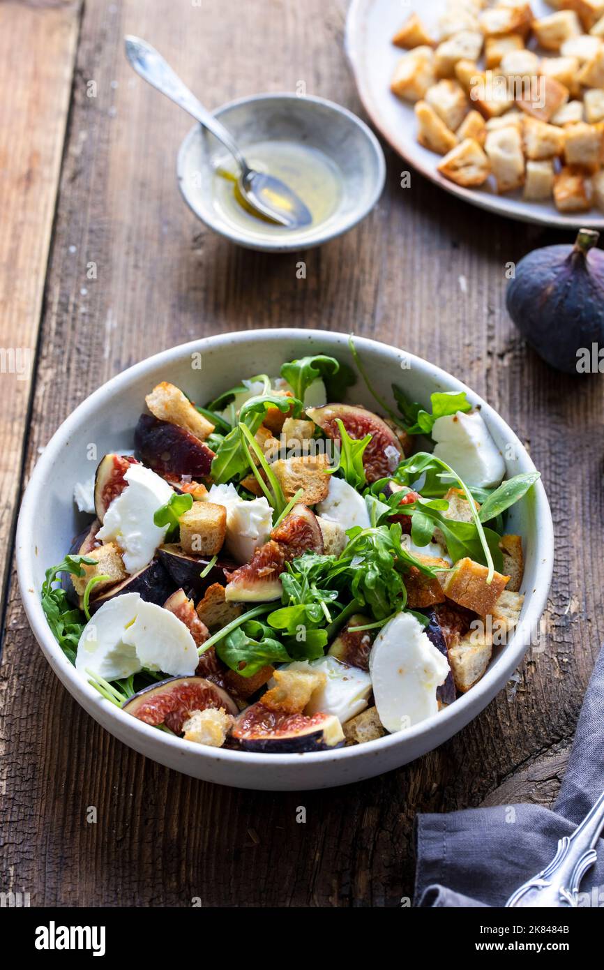 Fig and mozzarella salad with croutons and rocket leaves Stock Photo