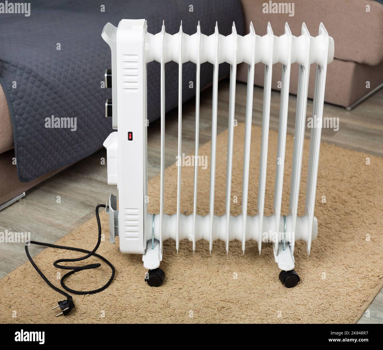 Electric oilfilled radiator for heating home in living room Stock Photo Alamy