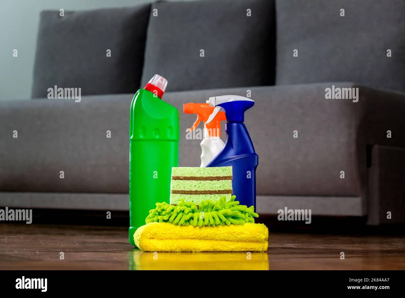 Household cleaning products and rags on floor. Chemical liquids for