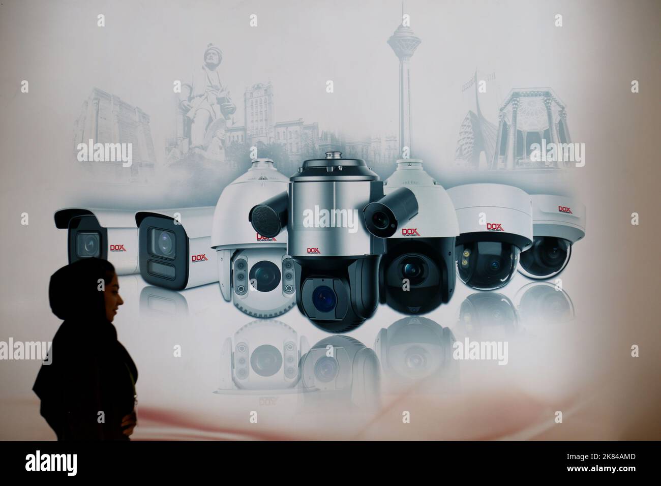 October 20, 2022, Tehran, Tehran, Iran: Iranian visitors walk past an advertising banner of the Exsom IP camera manufacturer company, at the 19th International Police Security and Safety Equipment Exhibition (IPAS 2022) at the grand Mosalla mosque in Tehran, Iran, on October 20, 2022. The idea to hold an IPAS exhibition took shape in 2001 with the initiative of the then Commander of the Law Enforcement Force of the Islamic Republic of Iran. The first term was held in the same year entitled, â€œ IPAS 2002: on March 2001 on police, security and safety equipment at the venue of the Conference Cen Stock Photo