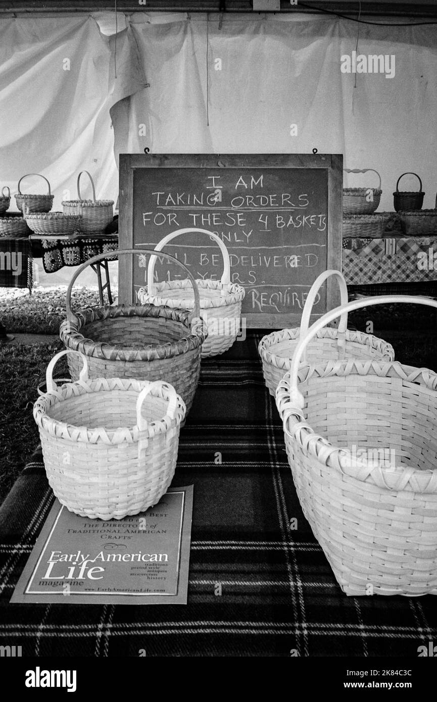 Hand-made baskets are on display with a chalkboard reading I Am Taking Orders for these 4 Baskets Only - Will Be Delivered In 1 - 2 Years at the Leagu Stock Photo