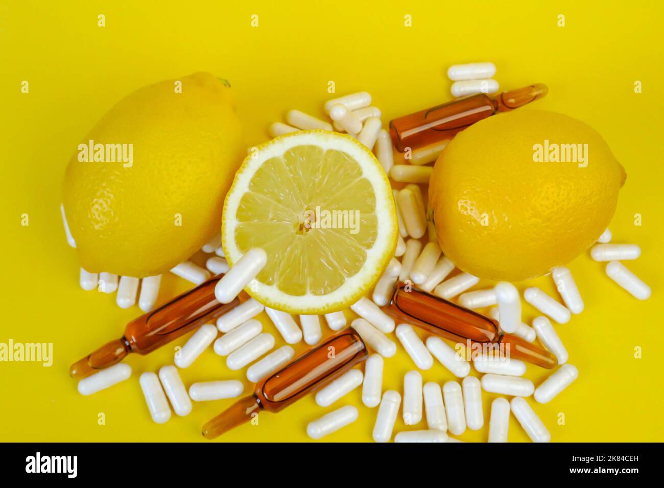 Vitamin C tablets on a yellow background.Flying vitamin C pills and