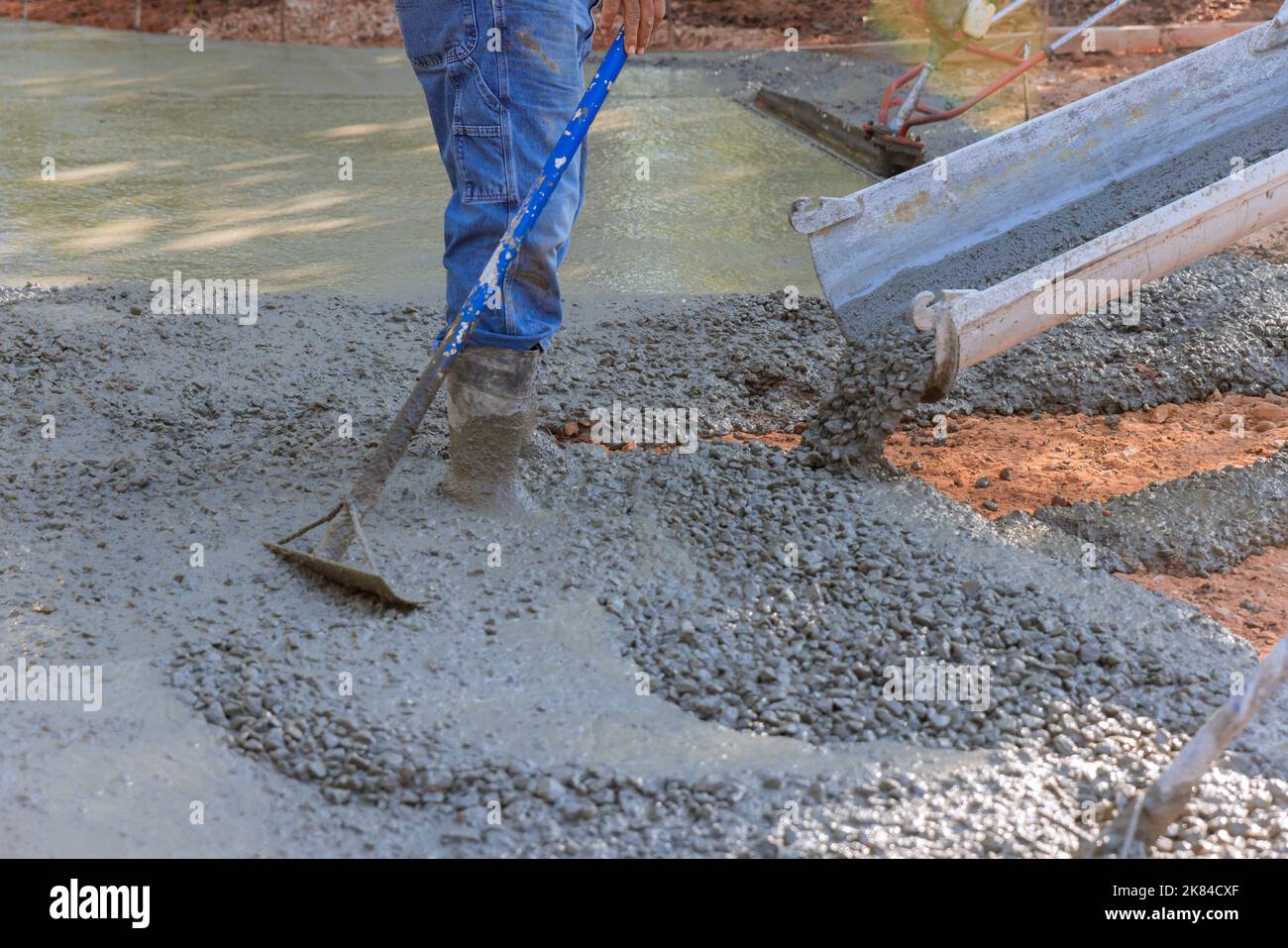 Paving driveway with wet concrete while concrete construction
