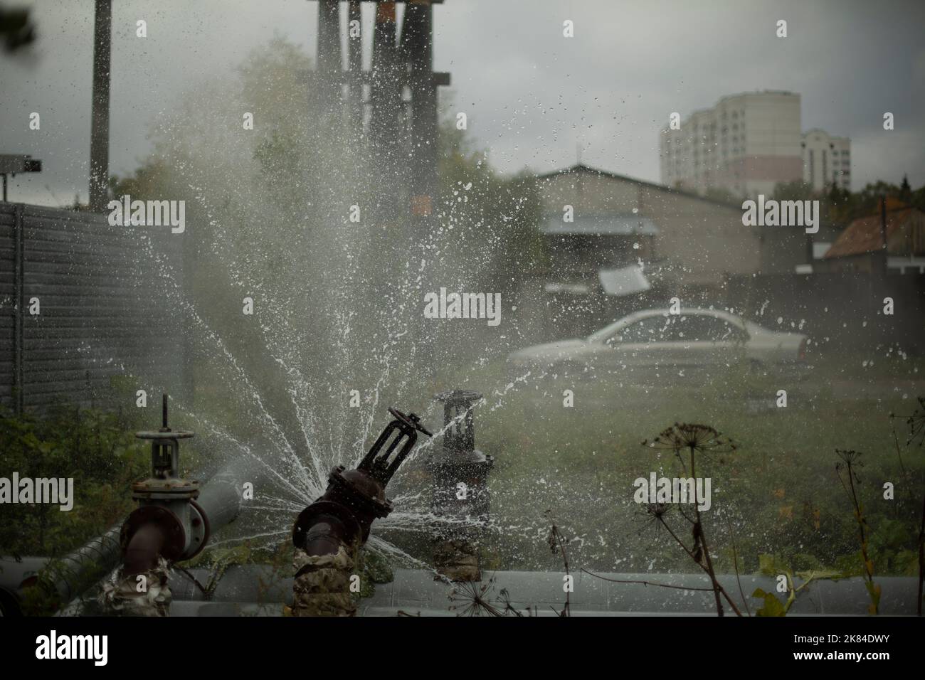 Burst pipe. Water pouring. Pipeline accident. It's dangerous situation. Jets of boiling water. Stock Photo