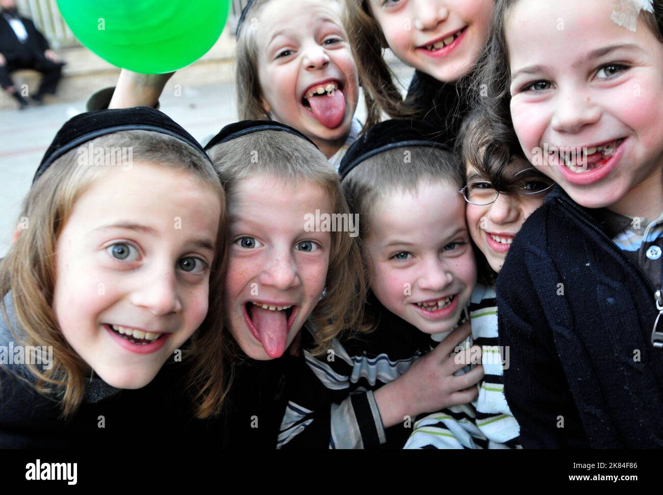 Cheerful & happy. Orthodox Jewish boys having fun in the courtyard of their Yeshiva in Jerusalem, Israel. Stock Photo