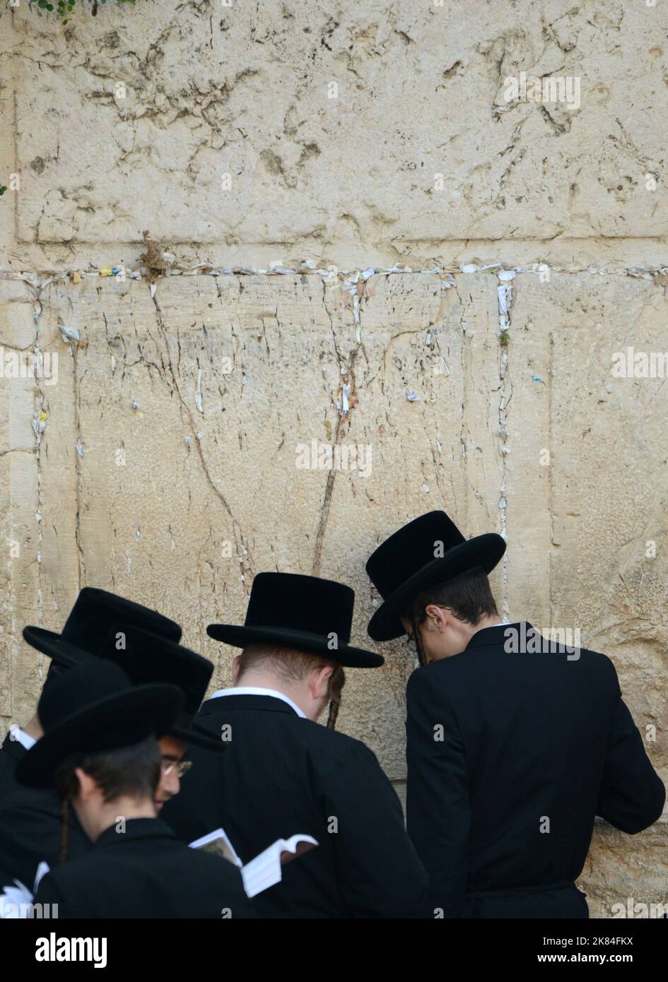Jewish men praying by the Wailing Wall / Western Wall in the Jewish quarter in the old city of Jerusalem, Israel. Stock Photo