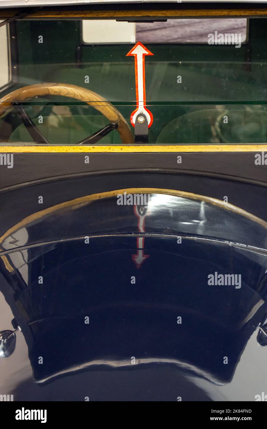 An windshield of a veteran car with direction indicator Stock Photo