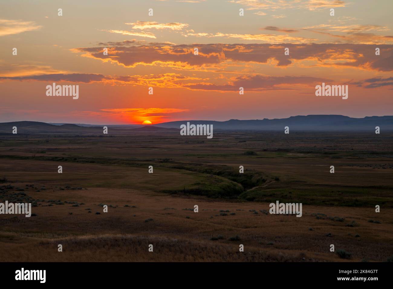 The sun sets over the Broken Hills and the Frenchman River in southern Saskatchewan's Grasslands National Park. The park protects one of Canada's few Stock Photo