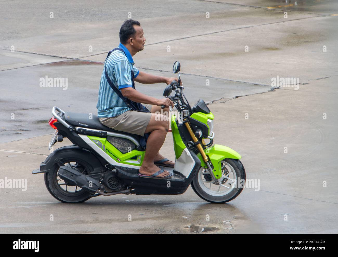 SAMUT PRAKAN, THAILAND, SEP 23 2022, A man with rides a motorcycle Stock Photo