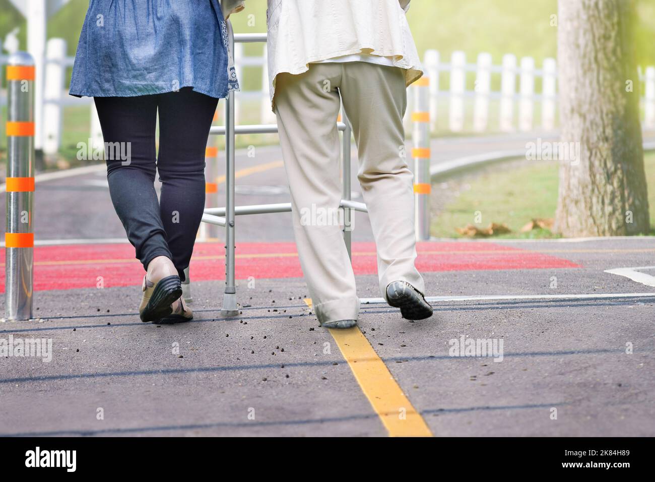 Elderly woman exercise walking in road with daughter with daughter Stock Photo