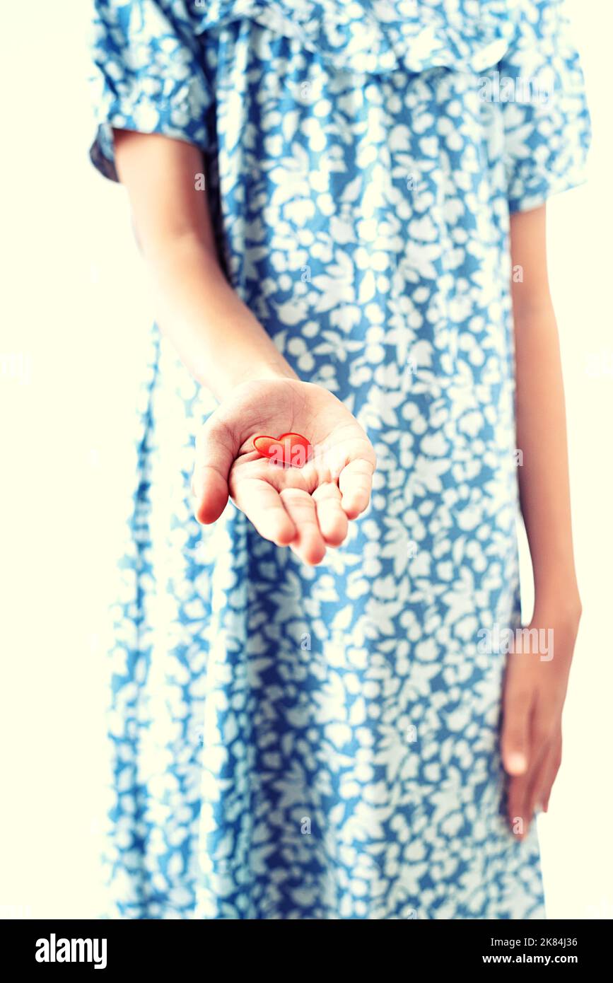 Close up girl's hand offering a heart Stock Photo