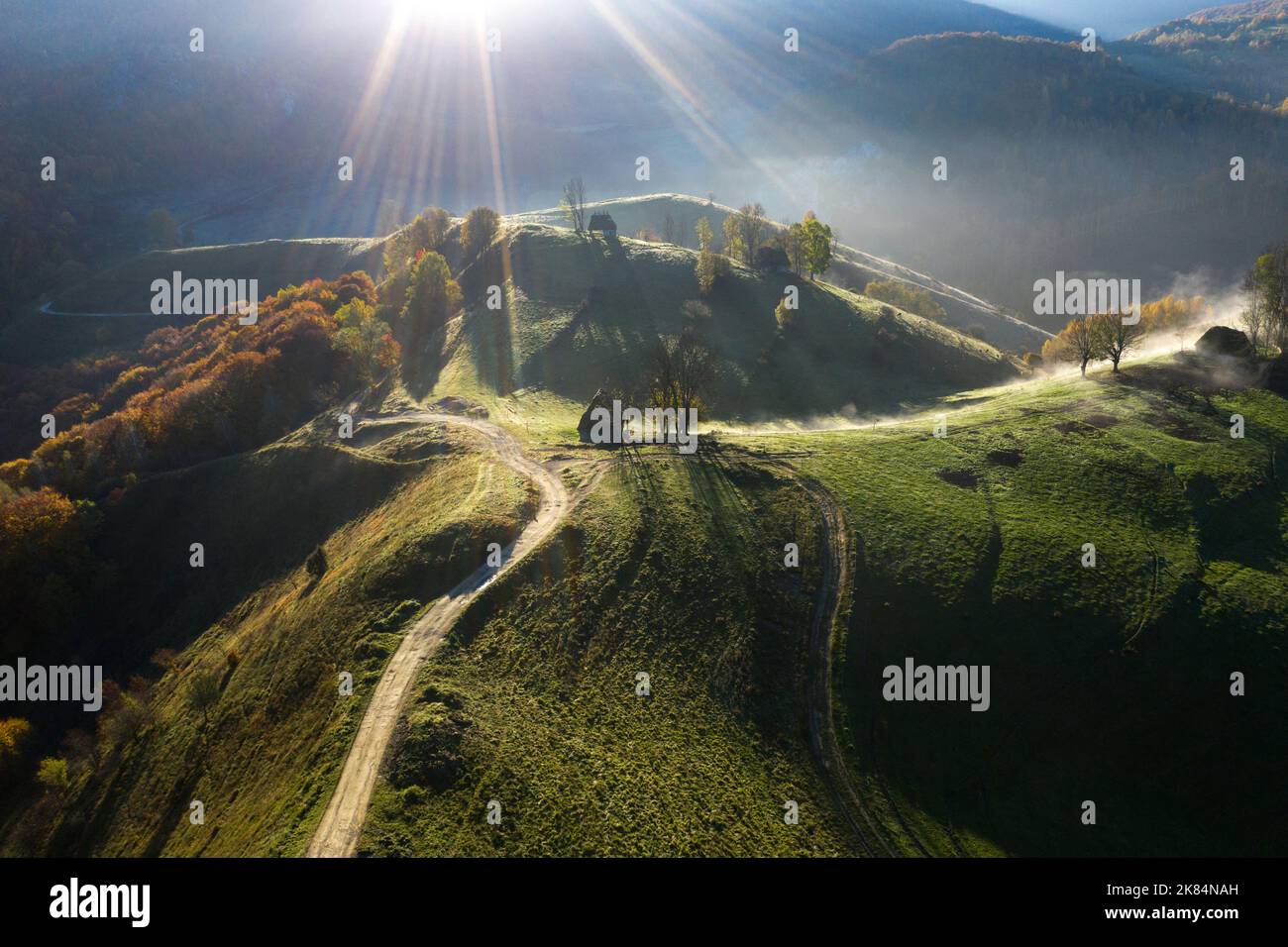 Aerial view of a mountain homestead in the autumn in early morning lights. Transylvania, Romania Stock Photo
