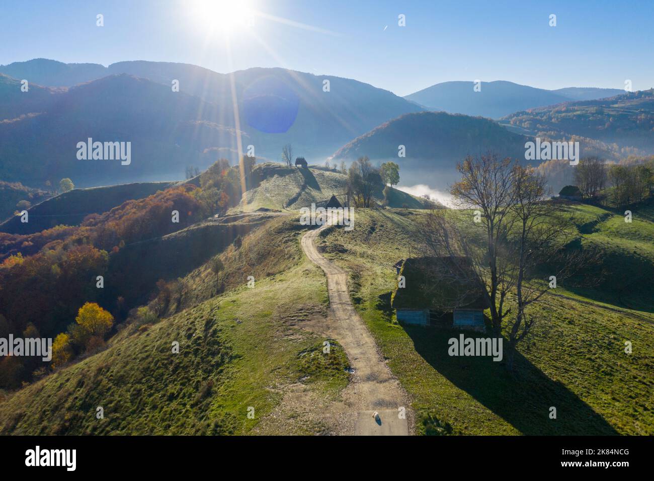 Aerial view of autumn countryside farm, with abandoned wooden houses and barns in the mountains. Transylvania, Romania Stock Photo