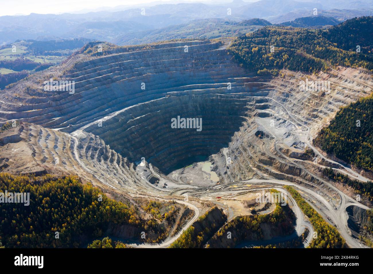 Flying above an open pit mine, copper excavation in Rosia Poieni, Romania. Aerial drone view Stock Photo
