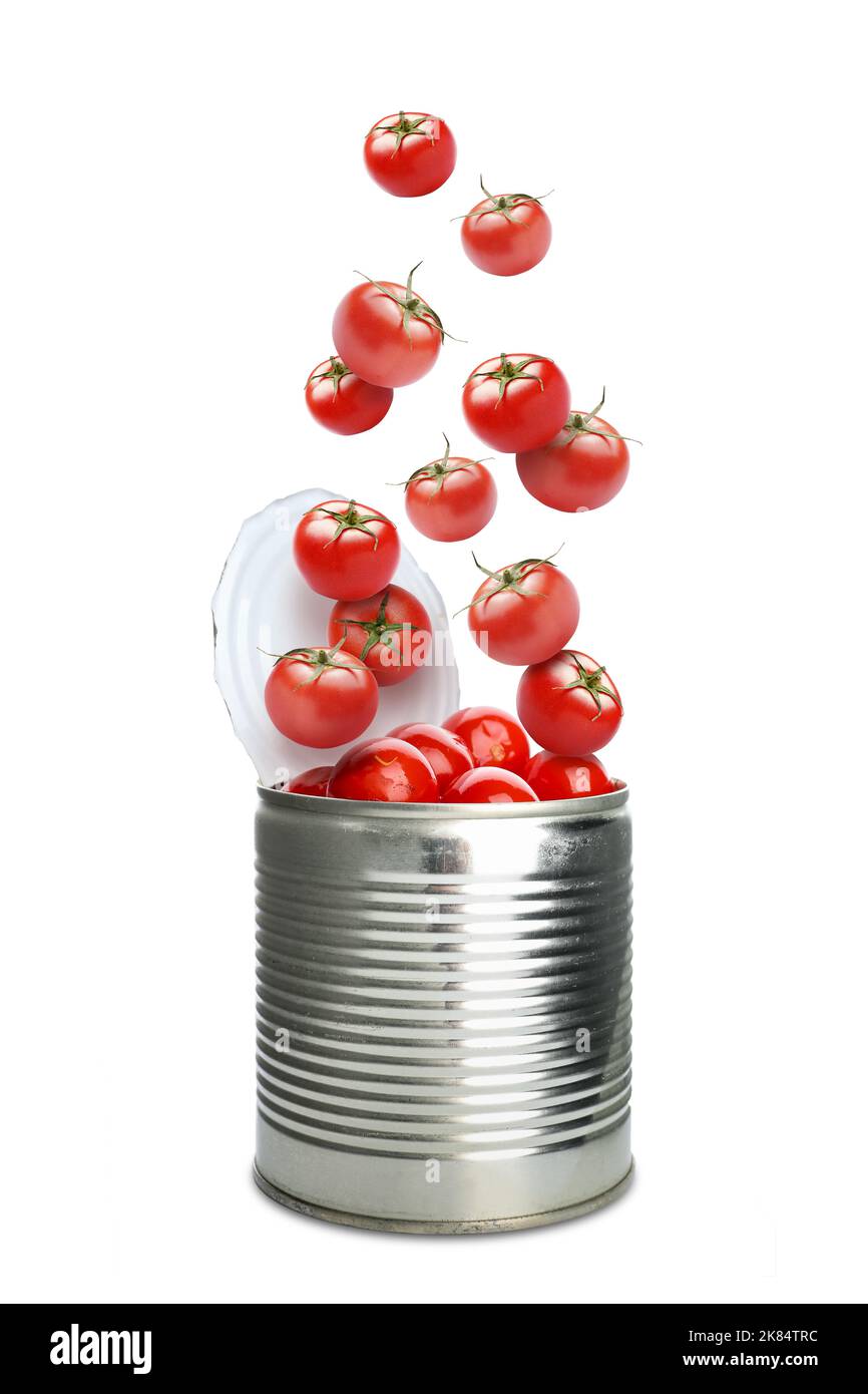 Open tin can with falling tasty tomatoes on white background Stock Photo