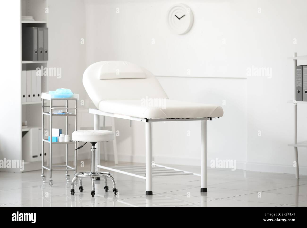 Interior of modern medical office with couch and table with doctor's ...