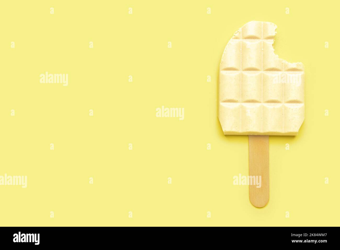 White chocolate bar and ice cream stick on color background Stock Photo