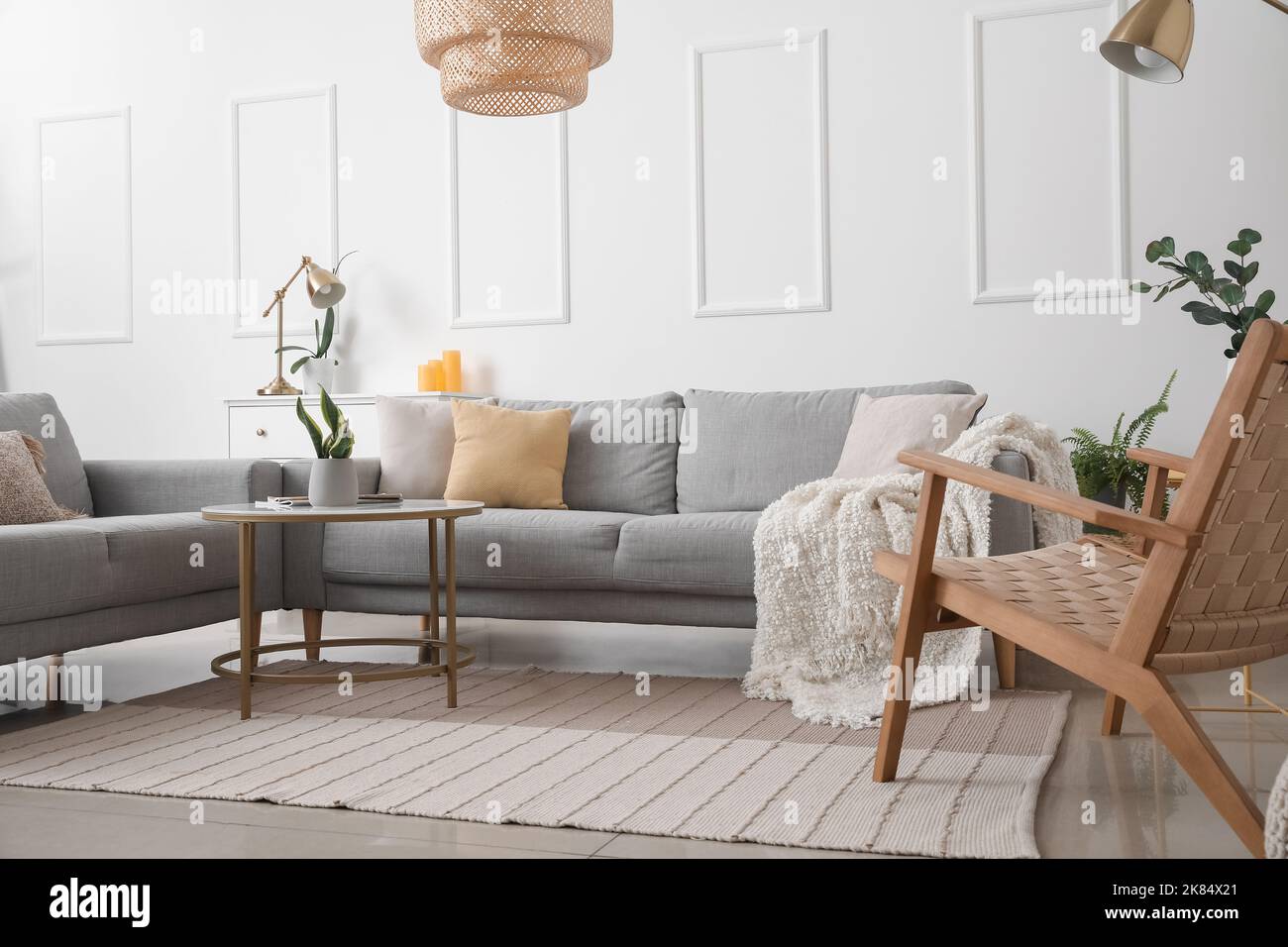 Interior of light living room with grey sofas and table Stock Photo - Alamy