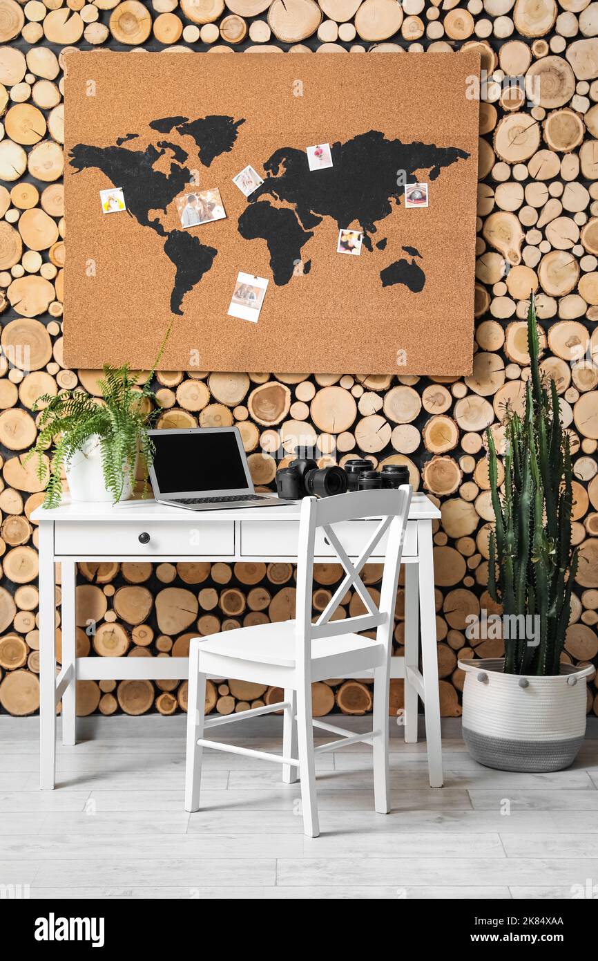 Interior of stylish office with photographer's workplace and world map ...