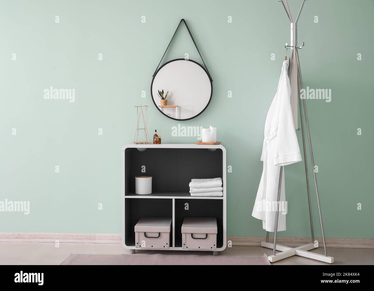 Interior of stylish bathroom with mirror, shelving unit and rack Stock ...