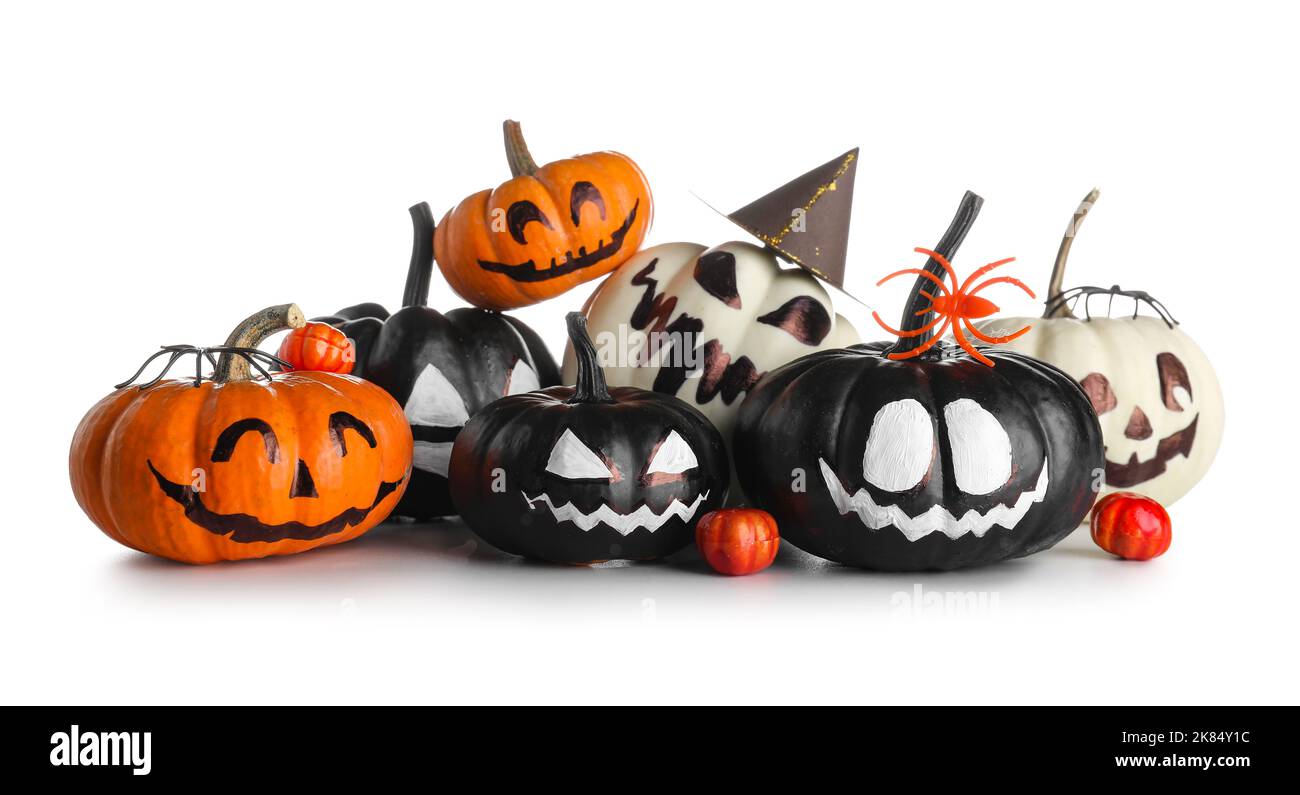 Halloween pumpkins with drawn faces and spiders on white background ...
