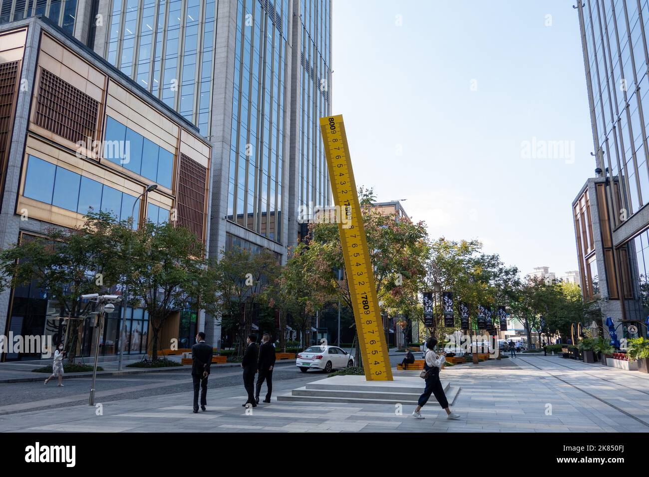 SHANGHAI, CHINA - OCTOBER 21, 2022 - A yellow ruler with a height of about three meters is seen on the square of the BFC Bund financial Center in Shan Stock Photo