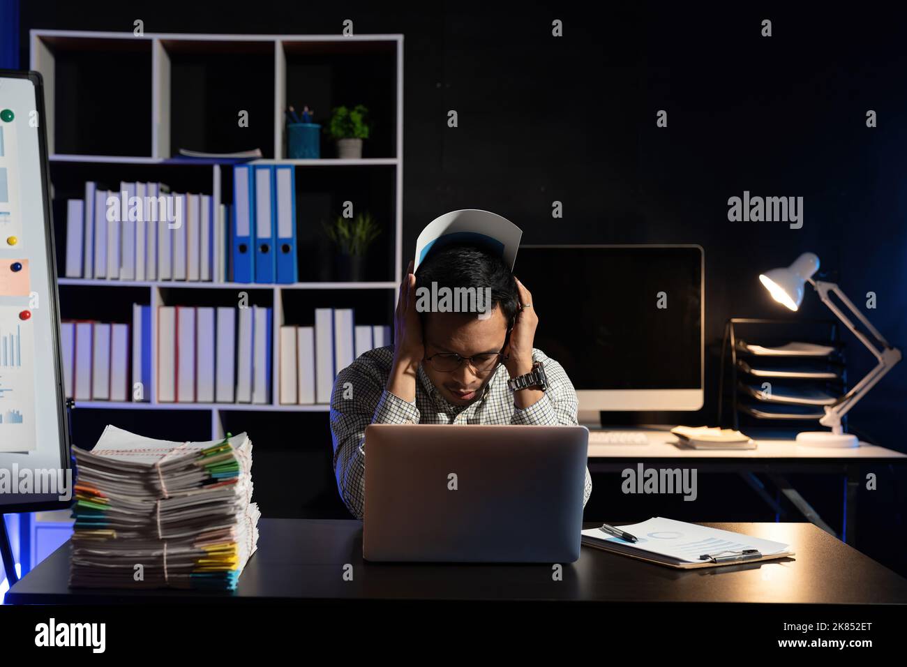 Businessman making mistake about financial business.Exhausted and tired worker surrendering to fatigue working and sleepy worker on desk with laptop Stock Photo