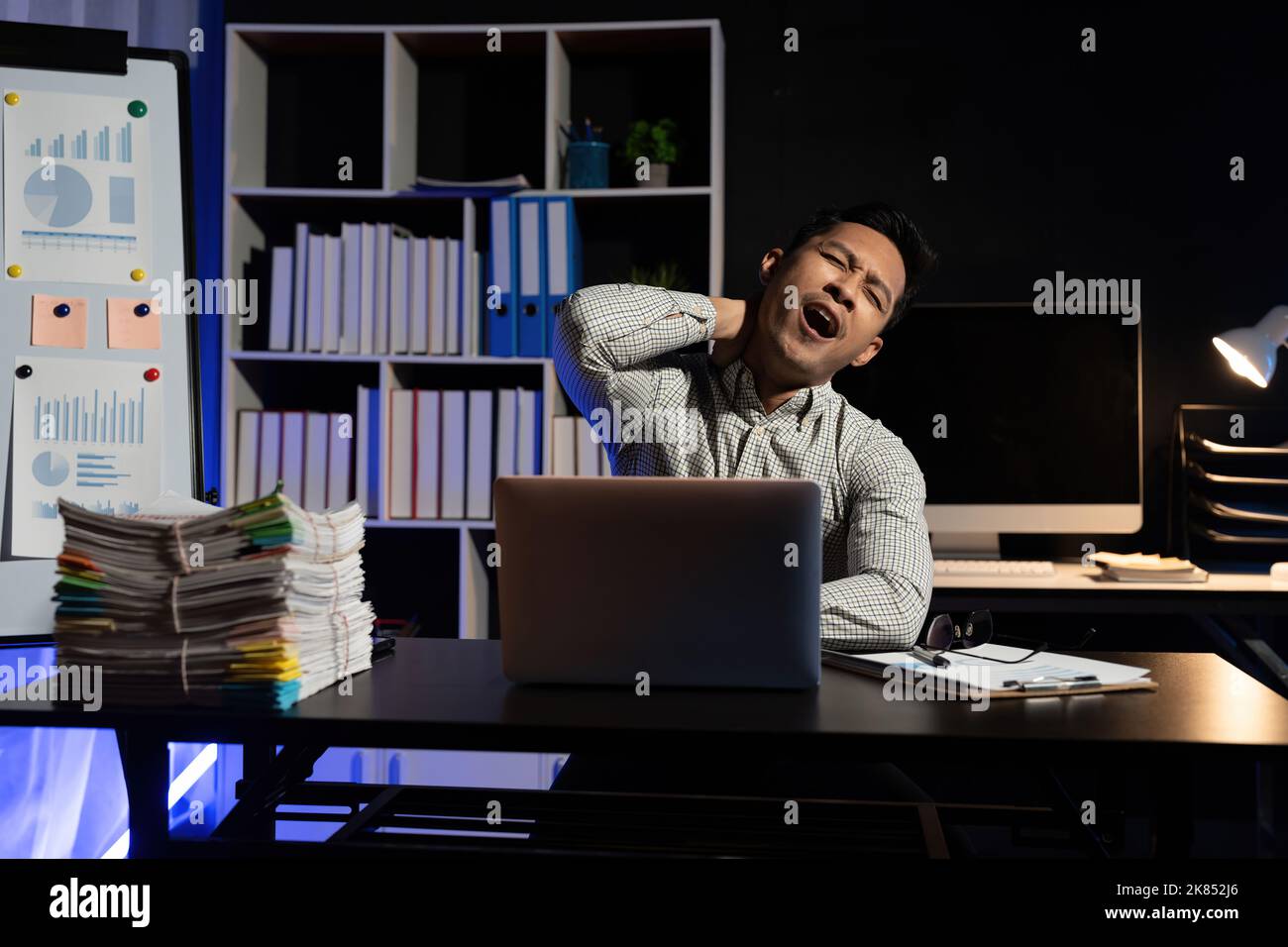 Yawn, burnout and tired businessman is sleepy in the office from deadlines, overworked and overwhelmed with fatigue. Mental health, yawning and Stock Photo