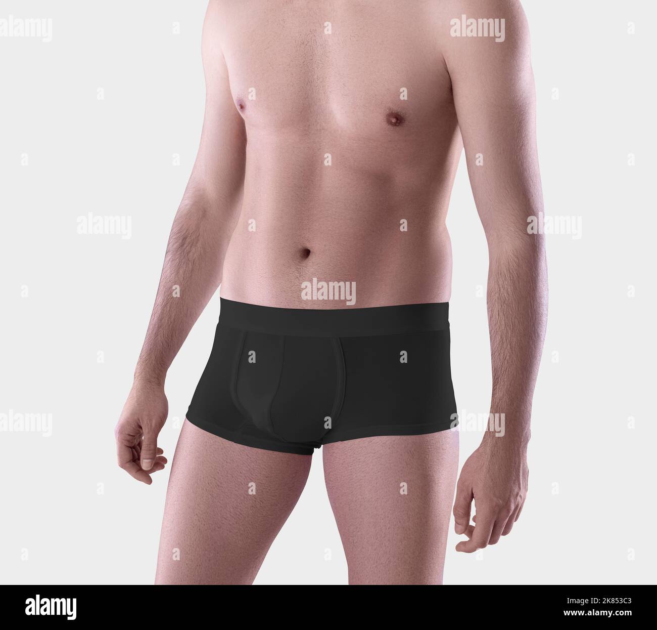 Mockup of black male boxers on the athletic body of a guy, brief underwear, isolated on background. Template of fashionable comfortable trunks, underp Stock Photo