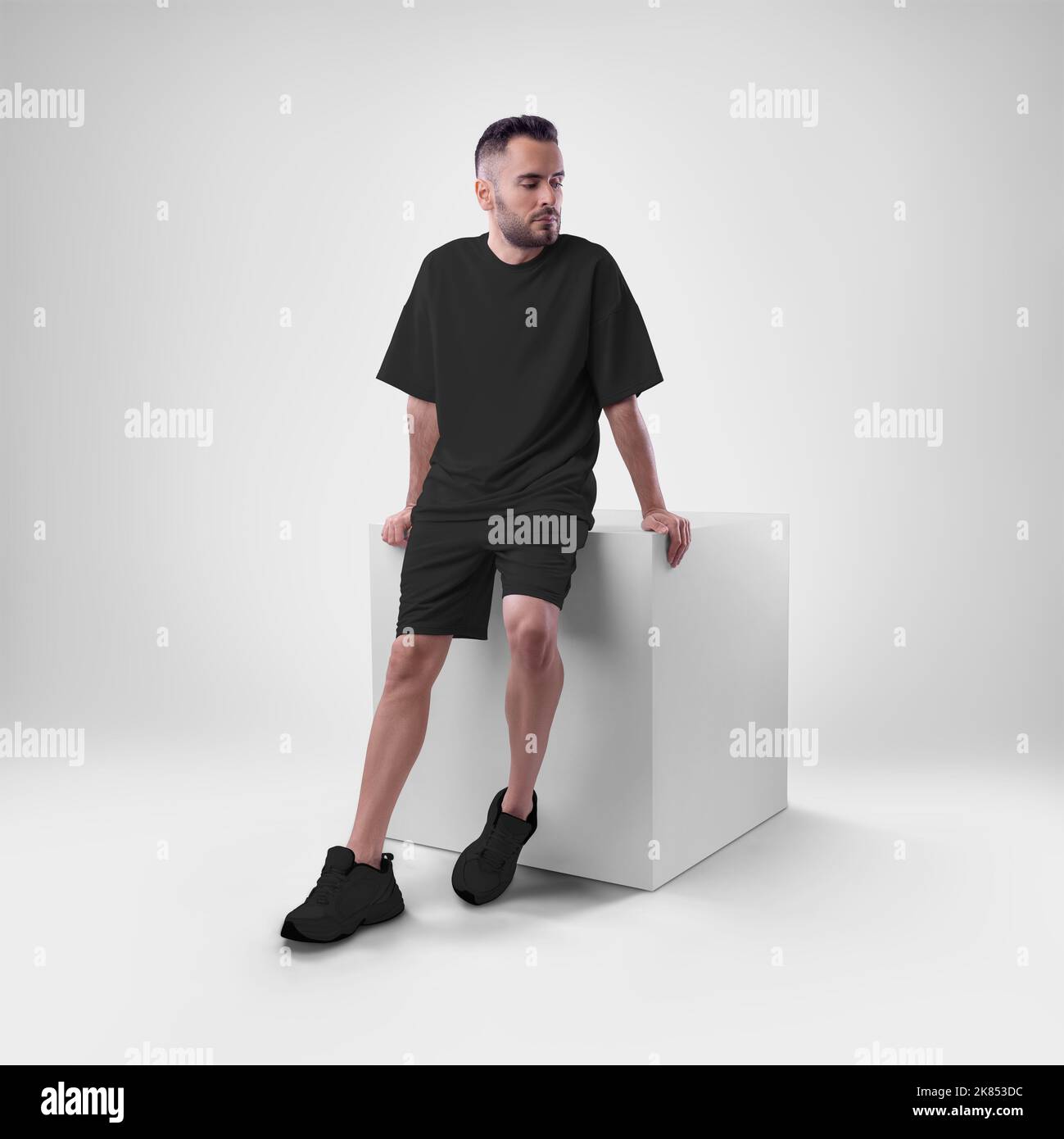 Mockup of black men's suit oversized tshirt on shorts on man on cube