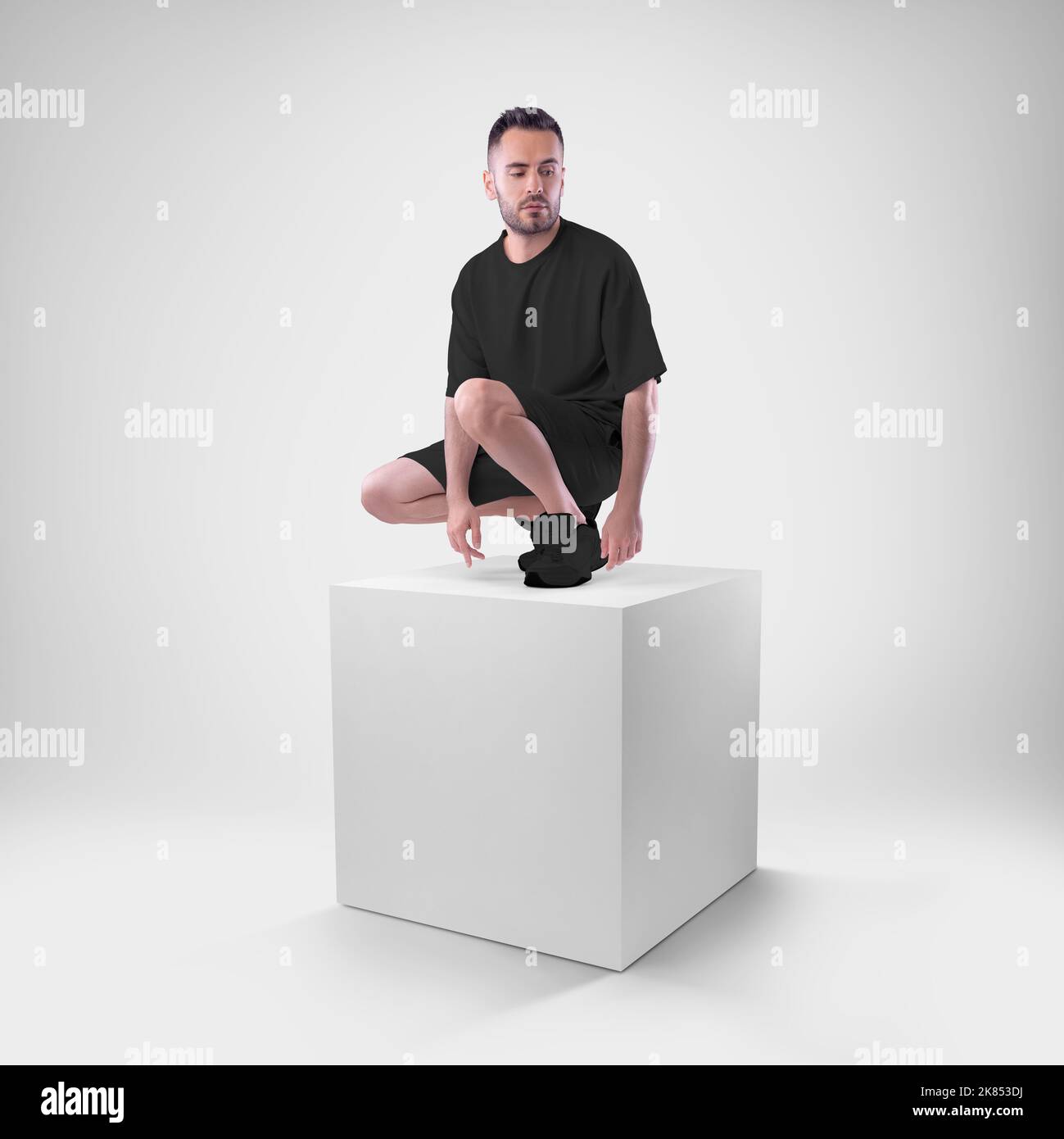 Mockup of black men's suit oversized tshirt on shorts on man on cube