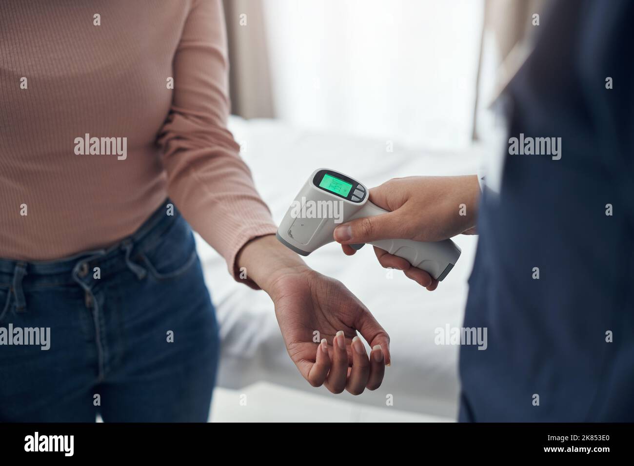 Regular temperature checks are crucial. an unrecognizable doctor using