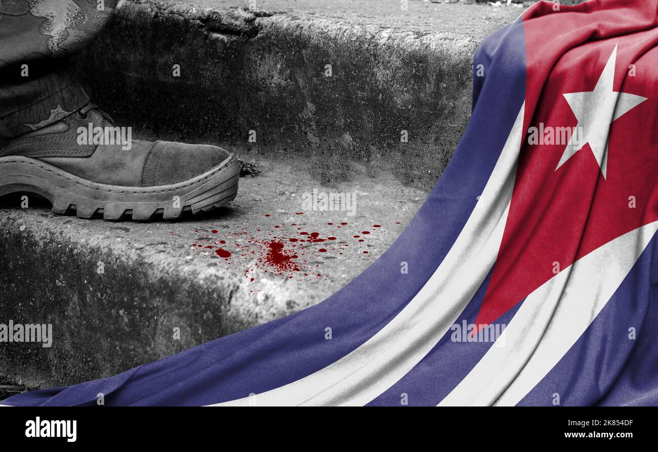 The leg of the military stands on the step next to the flag of Cuba, the concept of military conflict Stock Photo