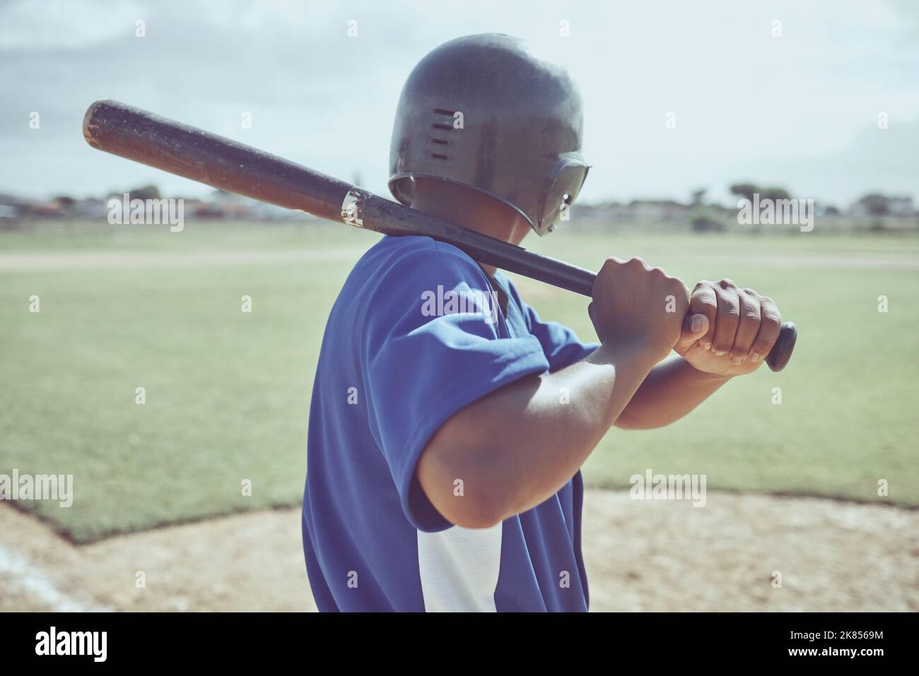 Baseball, baseball batter and back view of black man on field ready to hit ball during match, game or competition. Sports, fitness and baseball player Stock Photo