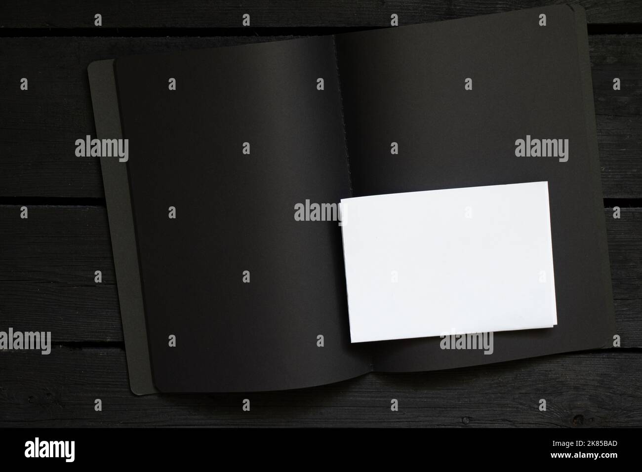 black notebook with white sheet and text on it 2022 on black wooden ...