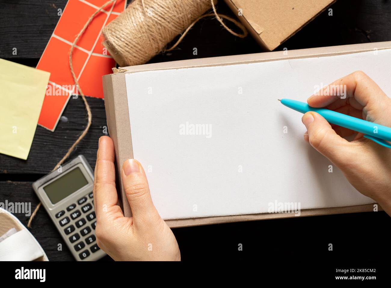 Women's online store, small business owner, entrepreneur, packing bag, mailbox preparing parcel on the table for shipping. Dropshipping delivery conce Stock Photo