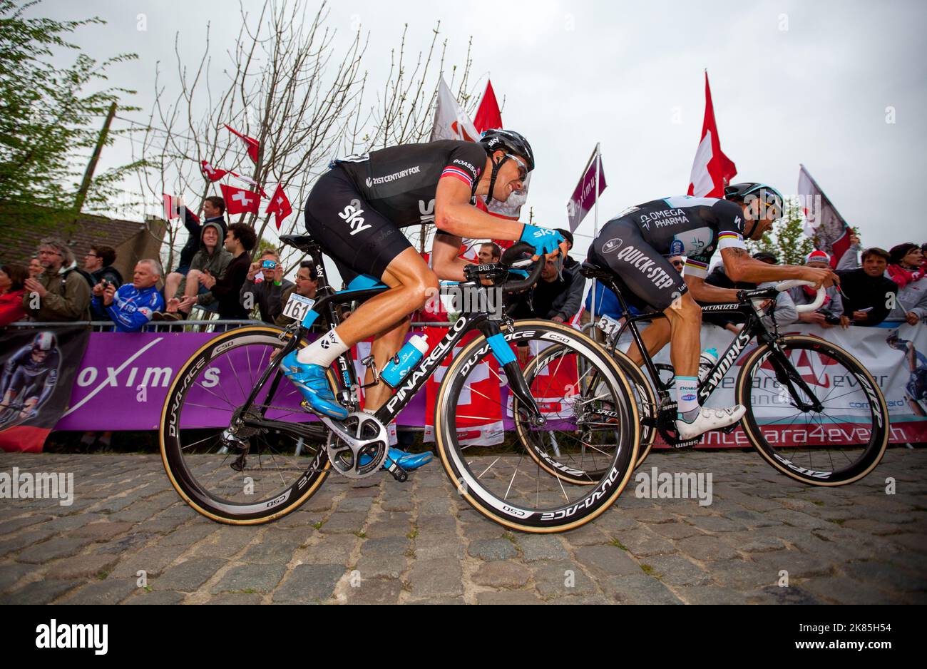 Team Sky's Edvald Boasson Hagen riding hard on the paterberg next to Omega Pharma's Tom Boonen during the 2014 Tour of Flanders Stock Photo