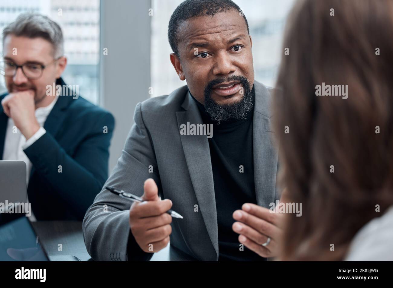 Let me explain. a group of corporate business colleagues having a meeting around the table in