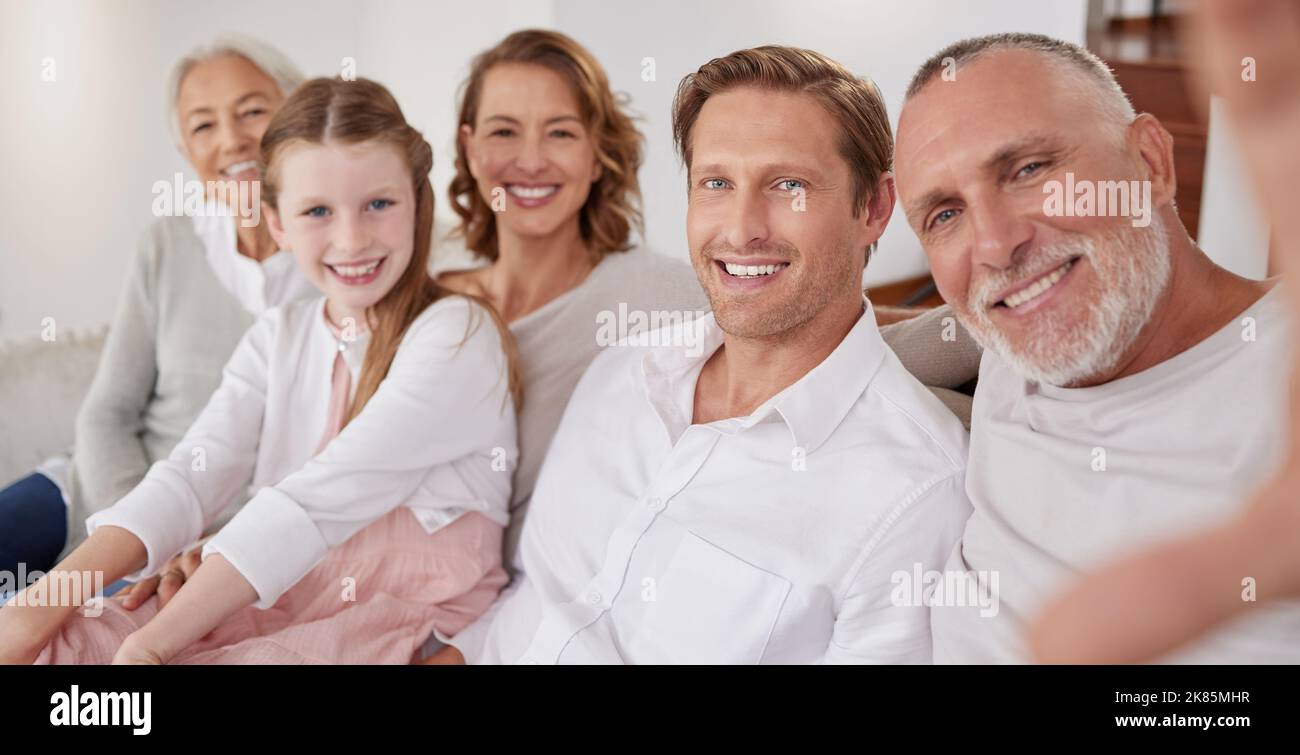 Selfie, happy and big family on the sofa in their living room for happiness, care and relax together in their house. Portrait of grandparents, parents Stock Photo