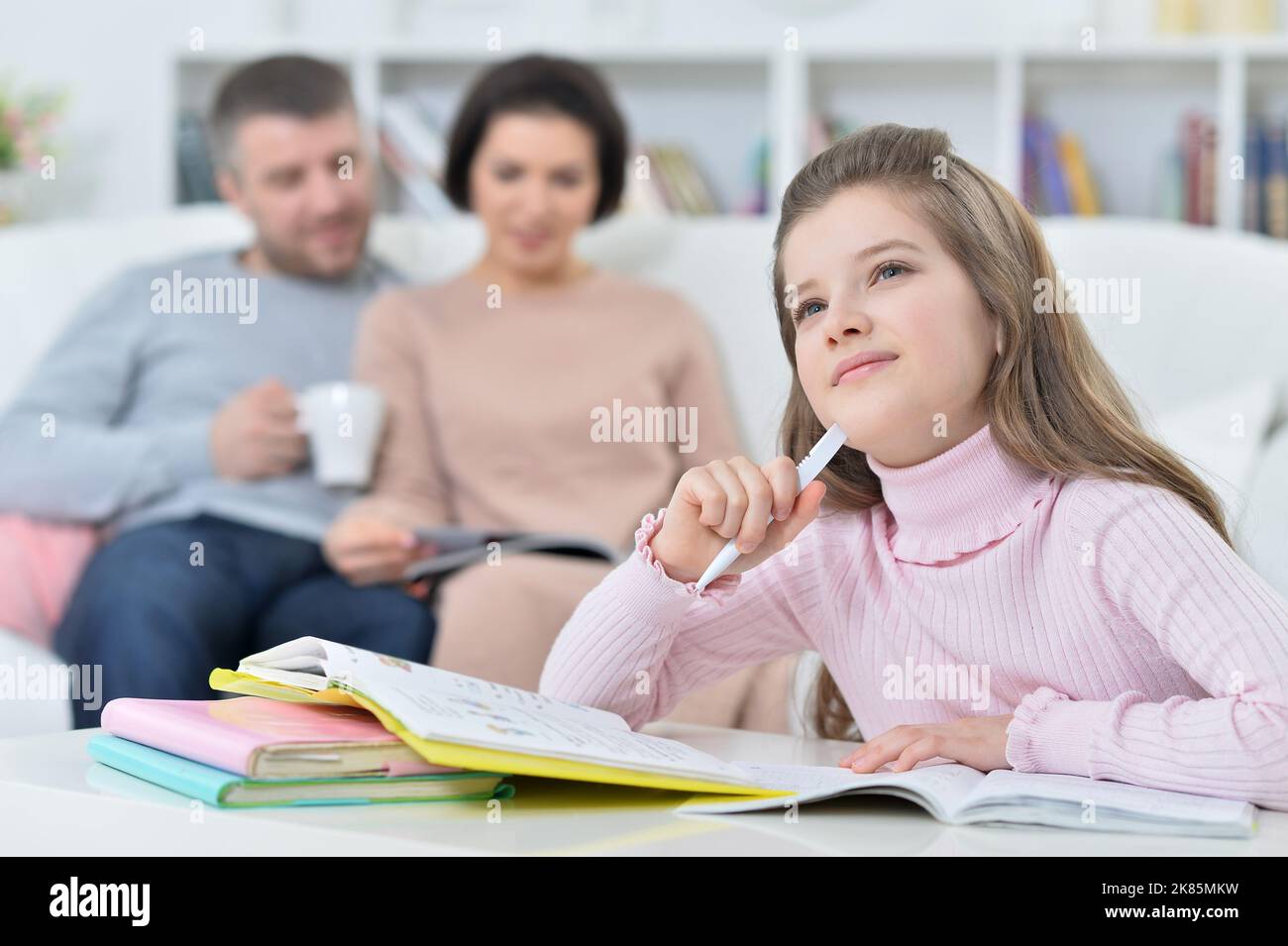 Beautiful little girl doing homework at home Stock Photo - Alamy